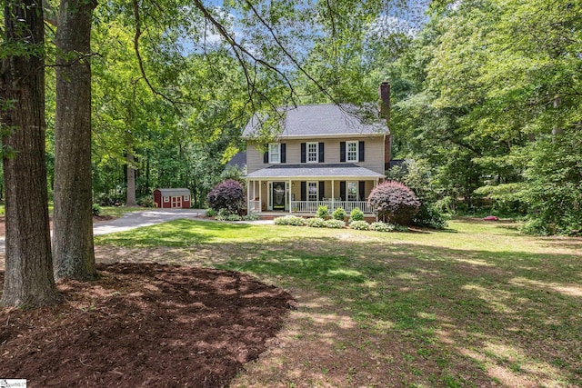 108 Ascot Ct, Easley, SC 29642 - colonial house featuring covered porch, a chimney, a front yard, and an outbuilding