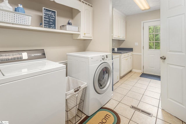 108 Ascot Ct, Easley, SC 29642 - laundry area with cabinet space, washing machine and dryer, and light tile patterned floors