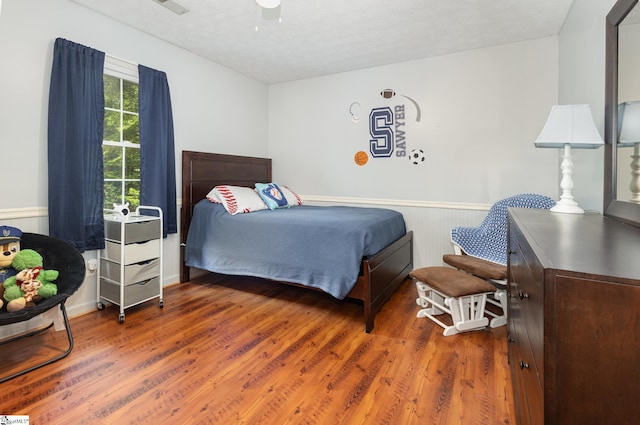 108 Ascot Ct, Easley, SC 29642 - bedroom featuring wood finished floors, a wainscoted wall, and a ceiling fan