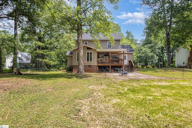 108 Ascot Ct, Easley, SC 29642 - rear view of property featuring a trampoline, a wooden deck, a lawn, and a patio area