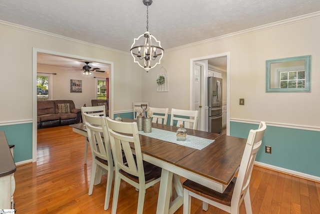 108 Ascot Ct, Easley, SC 29642 - dining space with a chandelier, crown molding, light wood-style floors, baseboards, and a ceiling fan