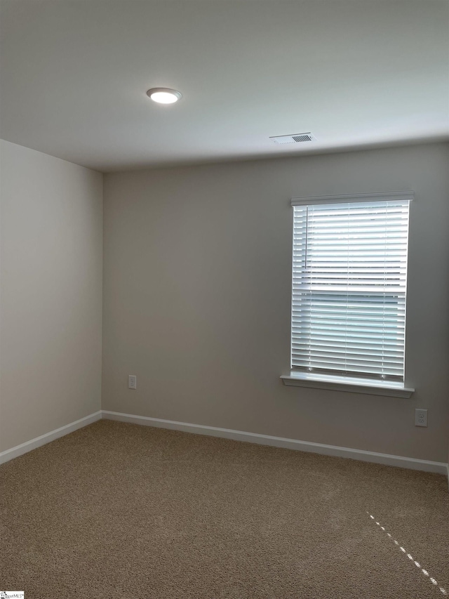 carpeted spare room with baseboards