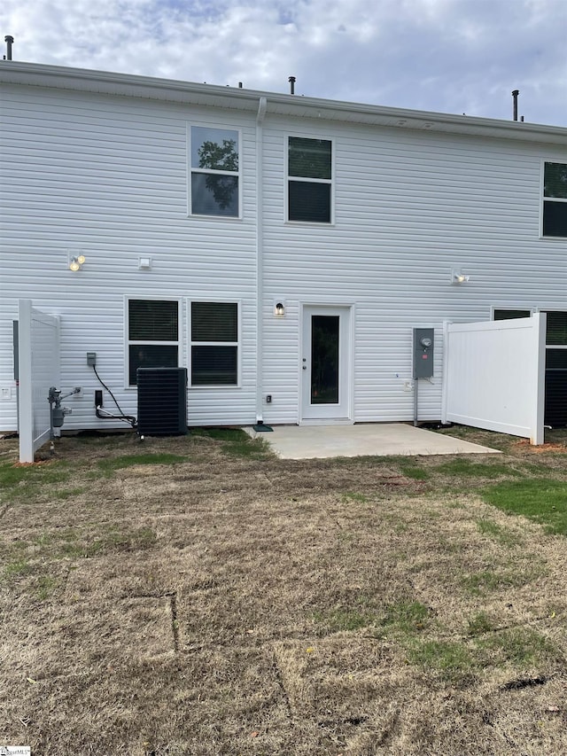 back of property with a patio area and central air condition unit