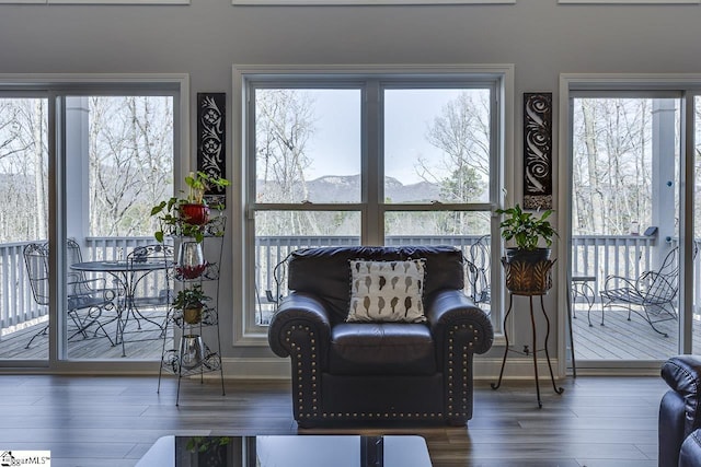 living area with wood finished floors and baseboards