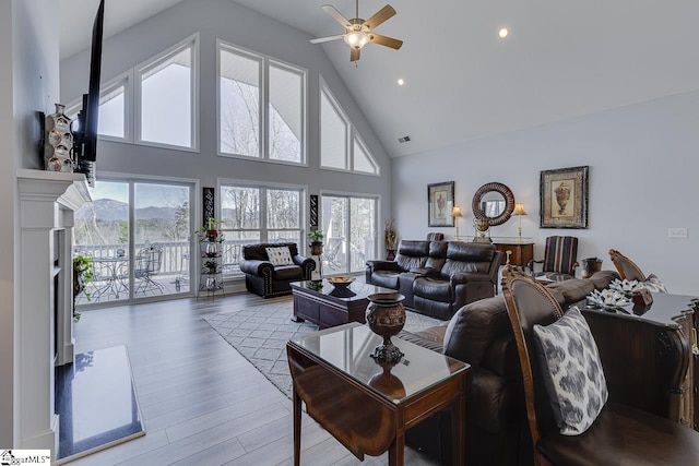 living room featuring high vaulted ceiling, ceiling fan, wood finished floors, and recessed lighting