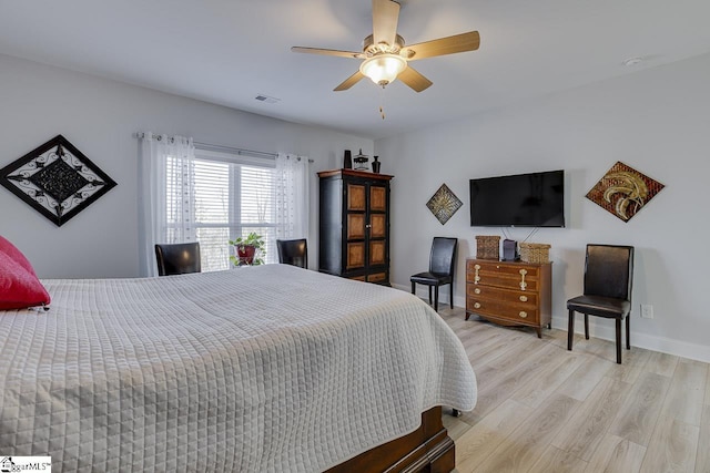 bedroom with light wood-type flooring, baseboards, and a ceiling fan