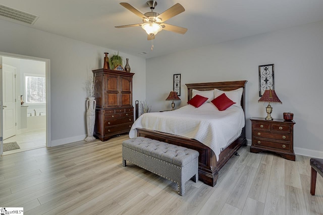 bedroom with light wood-style floors, baseboards, ceiling fan, and ensuite bathroom