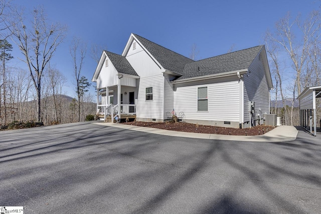 view of front of house with covered porch, a shingled roof, crawl space, and central AC unit