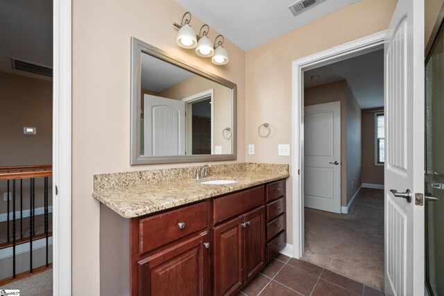 bathroom featuring baseboards, vanity, and tile patterned floors