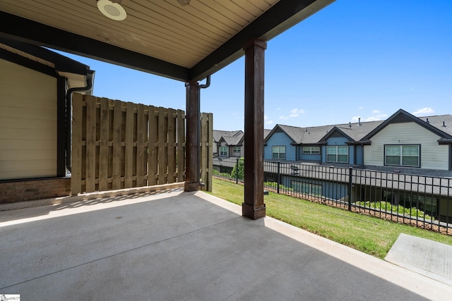 view of patio / terrace with a residential view and fence