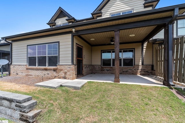 back of house featuring brick siding, a patio area, and a ceiling fan