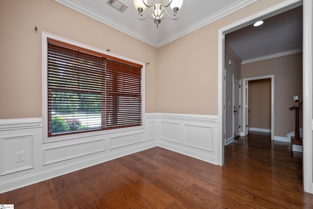 unfurnished room featuring a chandelier, dark wood-type flooring, ornamental molding, and wainscoting