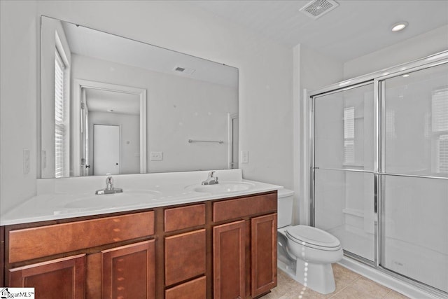 full bathroom with toilet, a shower stall, double vanity, and tile patterned flooring
