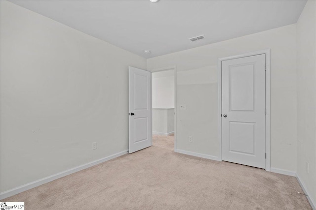 unfurnished bedroom featuring carpet and baseboards