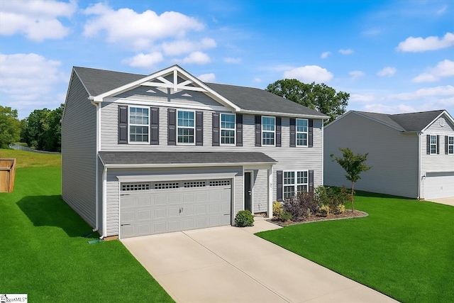 view of front of home featuring driveway, a garage, and a front lawn