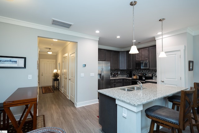 202 Button Willow St, Taylors, SC 29687 - kitchen with appliances with stainless steel finishes, a sink, crown molding, dark brown cabinetry, and tasteful backsplash