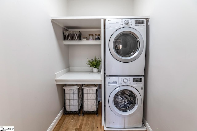 290 Coves End Pt, Seneca, SC 29678 - laundry room featuring stacked washer / dryer, wood finished floors, and baseboards