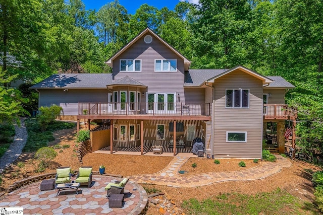290 Coves End Pt, Seneca, SC 29678 - back of house featuring a patio area, a wooden deck, a shingled roof, and a fire pit