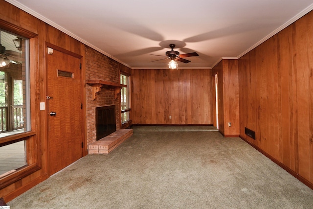 200 Lavonne Ave, Easley, SC 29642 - unfurnished living room with a ceiling fan, carpet, wood walls, a fireplace, and ornamental molding