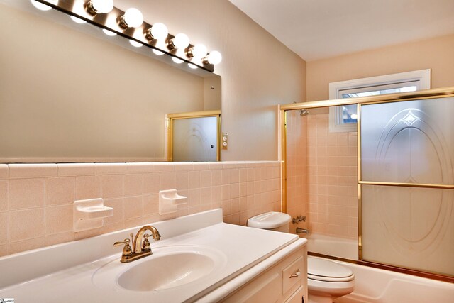 200 Lavonne Ave, Easley, SC 29642 - full bathroom featuring tile walls, toilet, combined bath / shower with glass door, and vanity