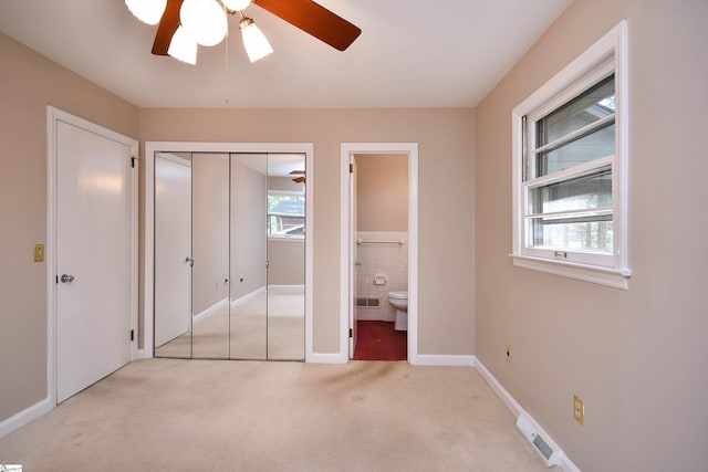 200 Lavonne Ave, Easley, SC 29642 - unfurnished bedroom with carpet floors, ensuite bath, a closet, baseboards, and a ceiling fan