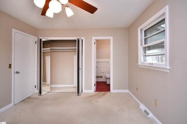 200 Lavonne Ave, Easley, SC 29642 - unfurnished bedroom with carpet floors, a closet, ensuite bath, tile walls, and ceiling fan