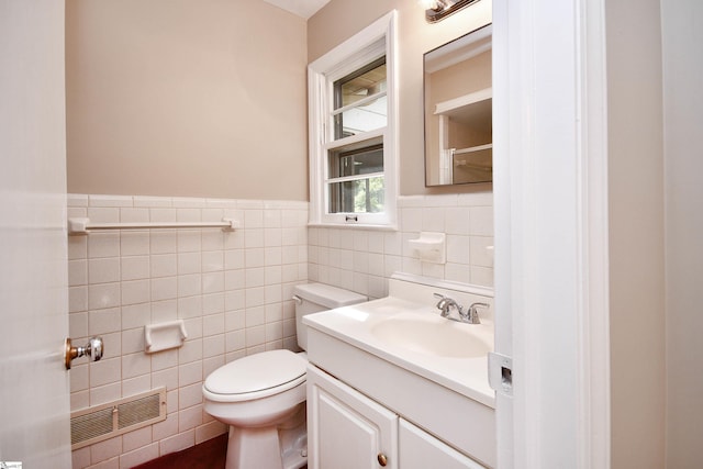 200 Lavonne Ave, Easley, SC 29642 - half bathroom with tile walls, toilet, vanity, and wainscoting