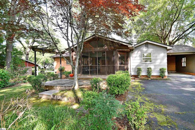 200 Lavonne Ave, Easley, SC 29642 - view of front of home featuring a sunroom, a deck, driveway, and an attached carport
