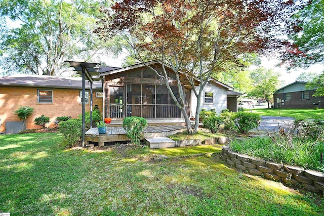 200 Lavonne Ave, Easley, SC 29642 - rear view of property featuring a sunroom, a lawn, brick siding, and a wooden deck
