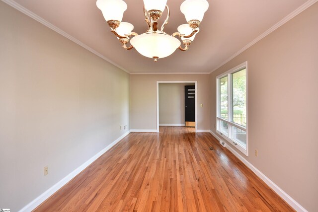 200 Lavonne Ave, Easley, SC 29642 - spare room featuring a chandelier, light wood-style flooring, baseboards, and ornamental molding