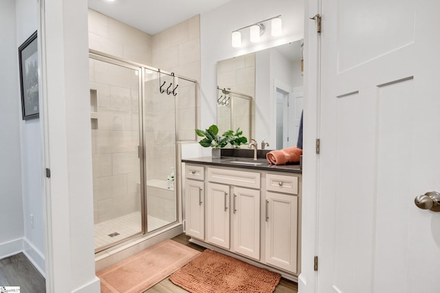 1560 Shallons Ct, Spartanburg, SC 29301 - bathroom featuring wood finished floors, a shower stall, and vanity