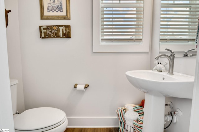 1560 Shallons Ct, Spartanburg, SC 29301 - half bathroom with toilet, healthy amount of natural light, and wood finished floors