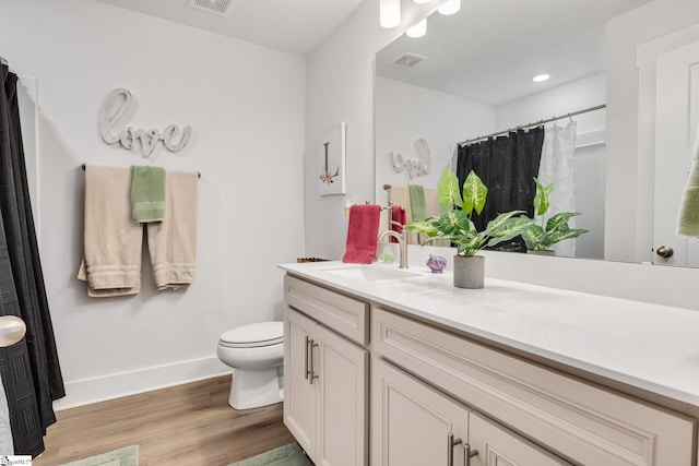 1560 Shallons Ct, Spartanburg, SC 29301 - bathroom with wood finished floors, toilet, vanity, baseboards, and curtained shower