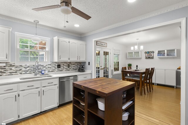 kitchen featuring stainless steel dishwasher, a sink, wood counters, open shelves, and ornamental molding