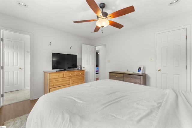 bedroom featuring wood finished floors, a ceiling fan, and recessed lighting