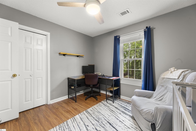 office area featuring wood finished floors, a ceiling fan, and baseboards