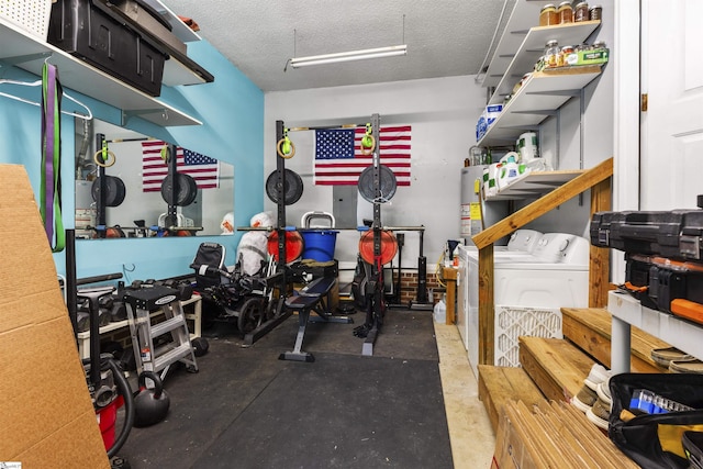 workout room featuring washing machine and dryer, gas water heater, and a textured ceiling
