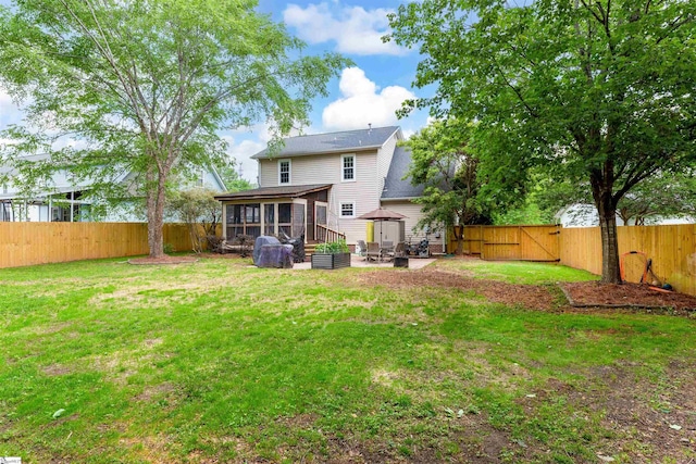 back of property featuring a sunroom, a gazebo, a gate, a patio area, and roof with shingles