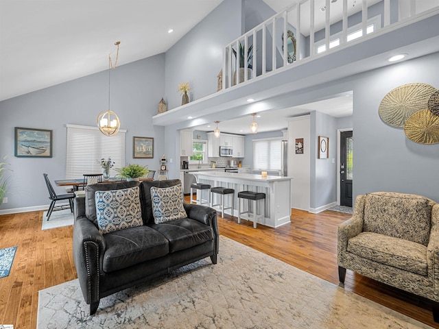 702 Lakewinds Blvd, Inman, SC 29349 - living area featuring high vaulted ceiling, light wood-type flooring, baseboards, a chandelier, and recessed lighting