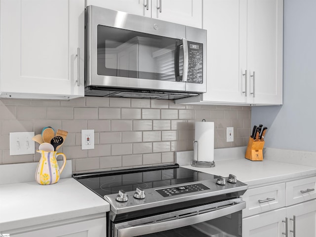 702 Lakewinds Blvd, Inman, SC 29349 - kitchen with stainless steel appliances, tasteful backsplash, white cabinets, and light countertops
