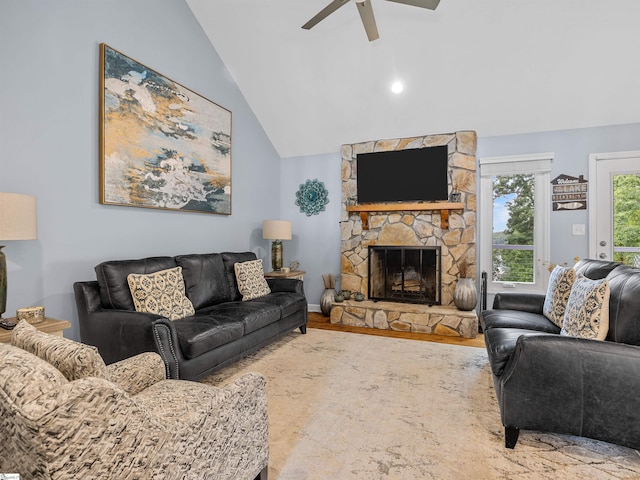 702 Lakewinds Blvd, Inman, SC 29349 - living area featuring ceiling fan, a stone fireplace, vaulted ceiling, wood finished floors, and baseboards