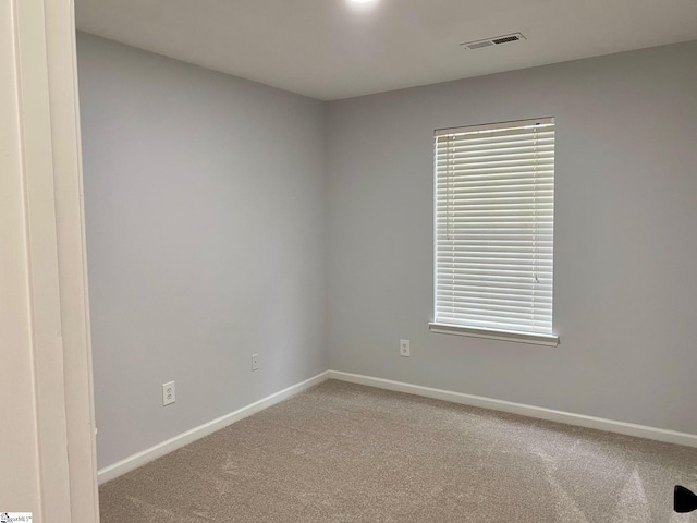 unfurnished room featuring carpet floors and baseboards