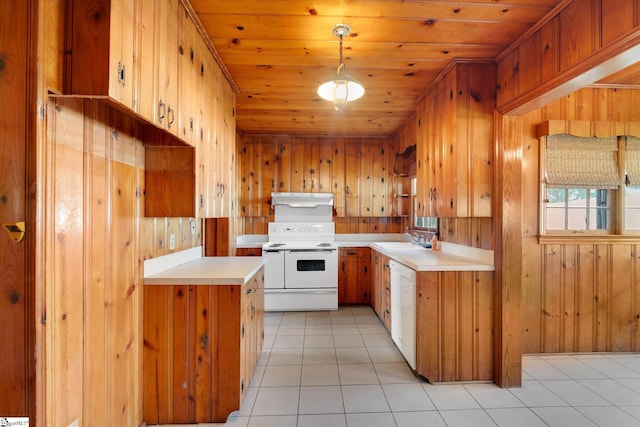 kitchen with white appliances, light countertops, light tile patterned flooring, wood walls, and wood ceiling