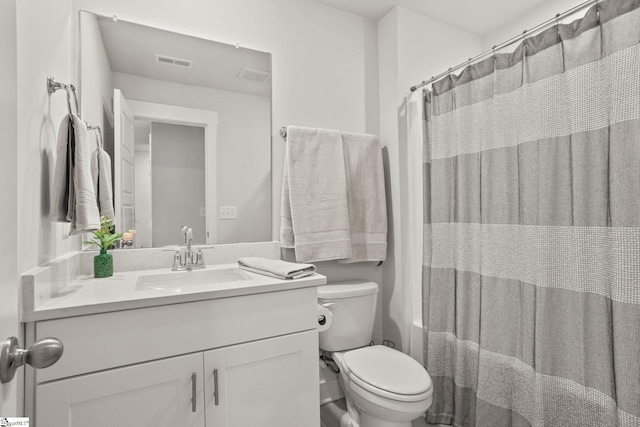 bathroom featuring toilet and vanity