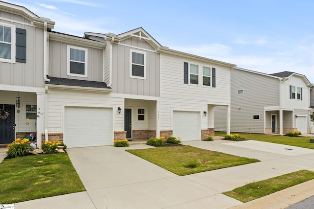 multi unit property featuring board and batten siding, brick siding, a garage, driveway, and a front yard