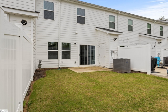 rear view of house with central AC unit and a patio
