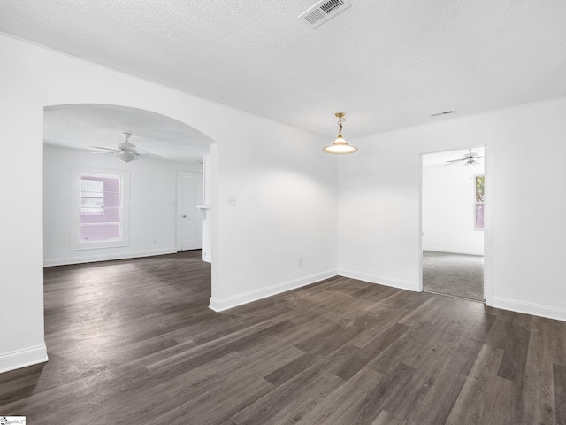7 Williams St, Spartanburg, SC 29301 - unfurnished room with ceiling fan, arched walkways, dark wood-type flooring, baseboards, and a textured ceiling