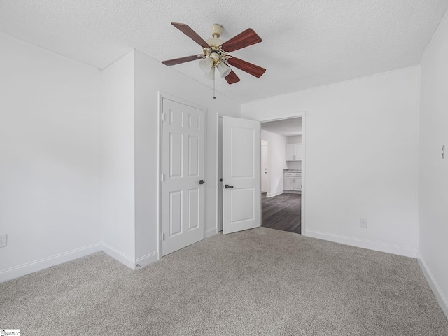 7 Williams St, Spartanburg, SC 29301 - unfurnished bedroom with carpet flooring, baseboards, a textured ceiling, and a ceiling fan