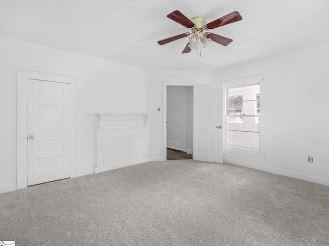 7 Williams St, Spartanburg, SC 29301 - unfurnished living room featuring carpet, a ceiling fan, baseboards, and a textured ceiling