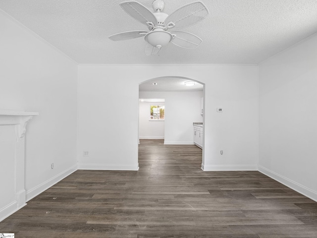7 Williams St, Spartanburg, SC 29301 - unfurnished living room with arched walkways, ceiling fan, a textured ceiling, wood finished floors, and baseboards
